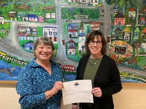 Newly appointed Mayor Liane Welch is presented her certificate by Interim Mayor Kathleen Baker